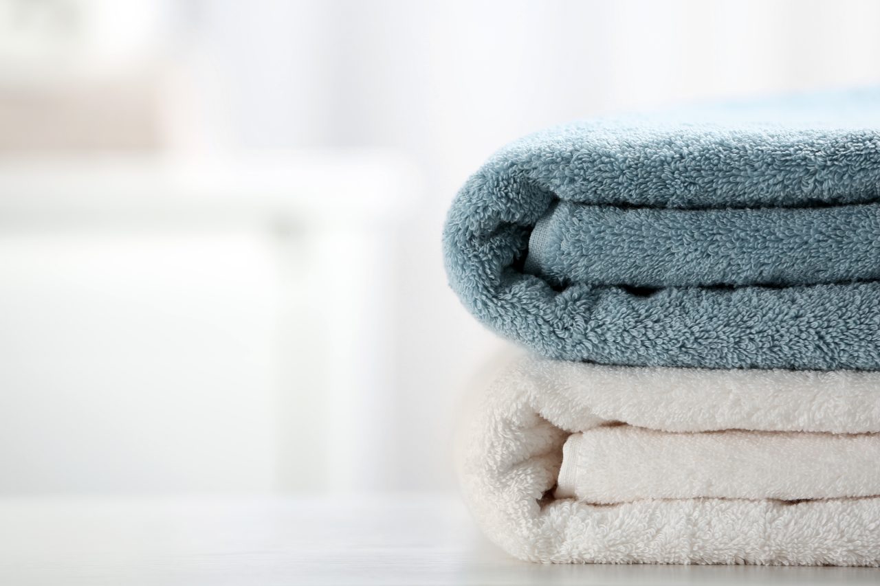 Stack,Of,Fresh,Towels,On,Table,,Closeup.,Space,For,Text