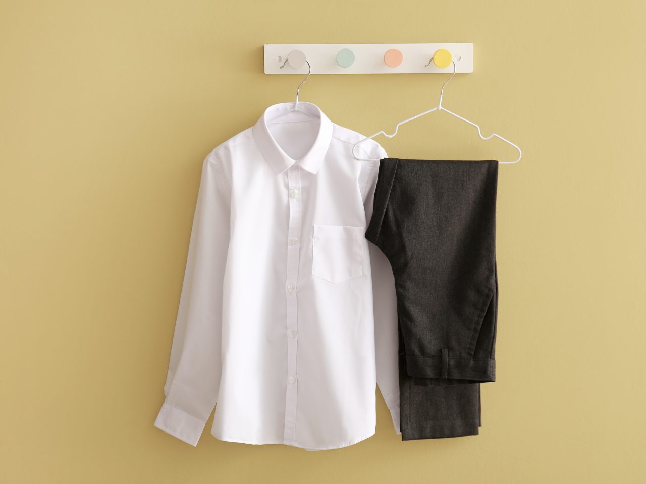 Stylish,School,Uniform,Hanging,On,Color,Wall