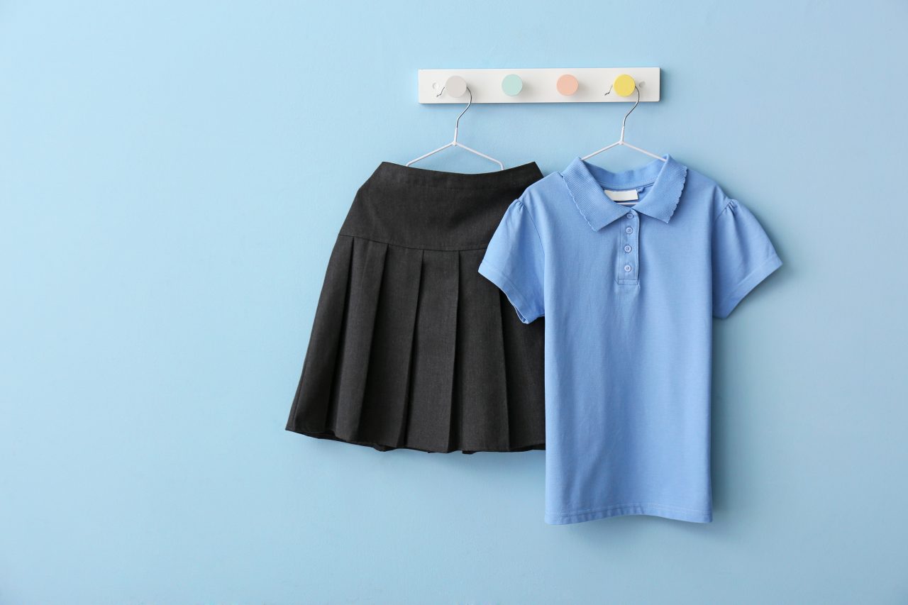 Stylish,School,Uniform,Hanging,On,Color,Wall
