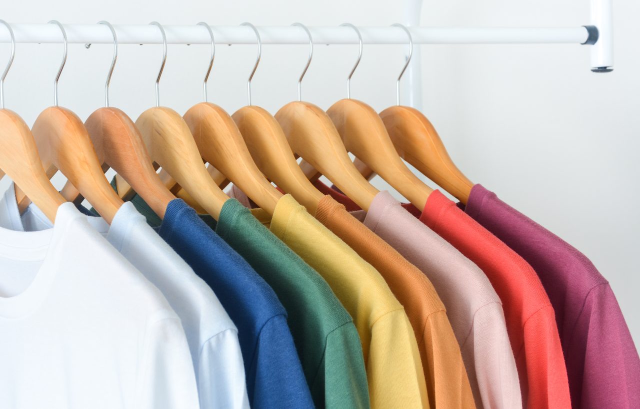 Close,Up,A,Collection,Of,Pastel,Color,T-shirts,Hanging,On
