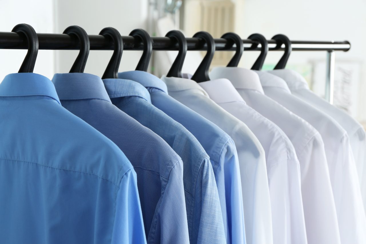 Clean,Shirts,Hanging,On,Rack,In,Laundry,,Closeup
